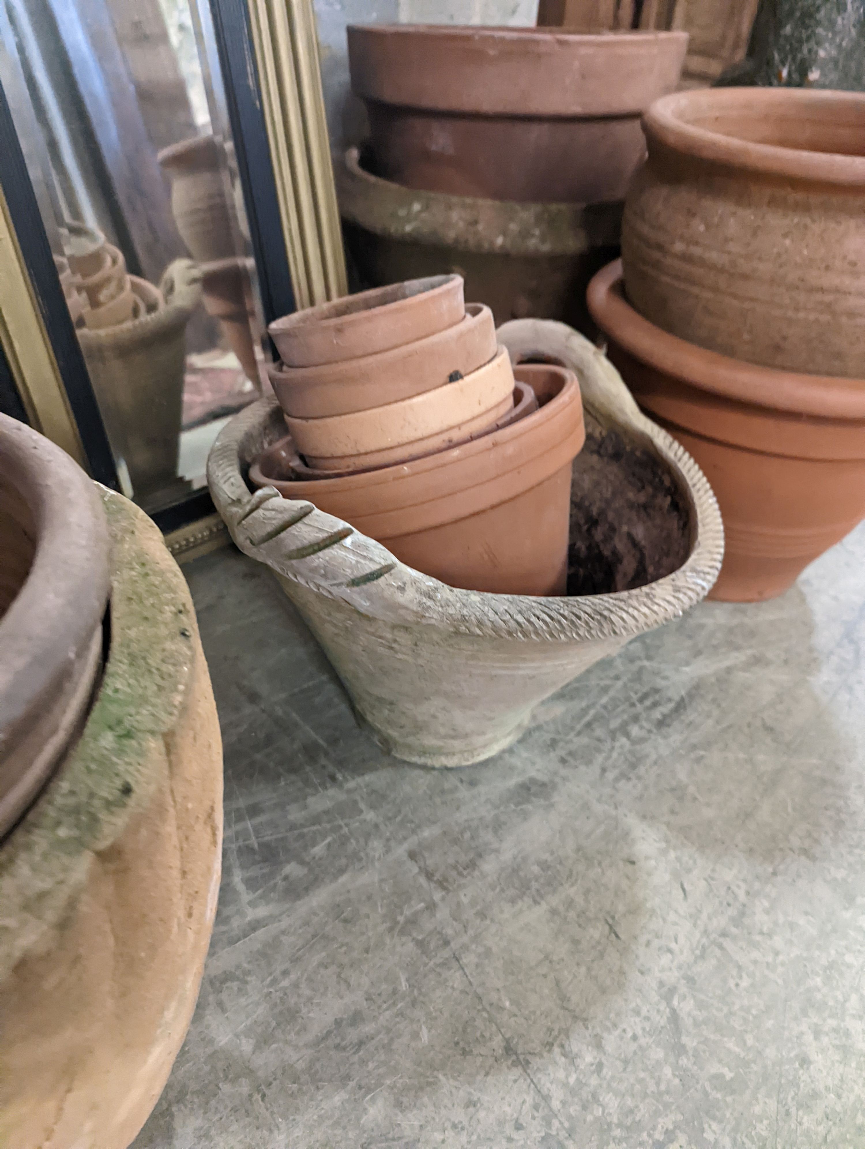 A collection of approximately 20 assorted terracotta garden planters, largest diameter 35cm